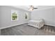 Cozy bedroom featuring neutral tones, two windows and grey carpeted floor at 100 Barnard Pl, Atlanta, GA 30328