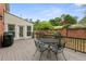Charming deck area with a metal table and chairs, ideal for outdoor relaxation, enhanced by a brick wall at 100 Barnard Pl, Atlanta, GA 30328