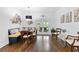 Bright dining area with built-in seating, wooden table, decor art and doors to the sun room at 100 Barnard Pl, Atlanta, GA 30328