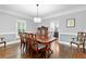 Elegant dining room with a large table, hardwood floors, and stylish decor at 100 Barnard Pl, Atlanta, GA 30328