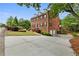 Classic brick home with black shutters, a well-manicured lawn and plentiful off street parking at 100 Barnard Pl, Atlanta, GA 30328