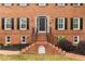 Traditional brick home with a welcoming front entrance and well-maintained landscaping at 100 Barnard Pl, Atlanta, GA 30328