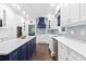 Bright, open kitchen with white countertops, stainless appliances, and a navy blue kitchen island at 100 Barnard Pl, Atlanta, GA 30328