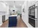 Modern kitchen with white cabinets, stainless steel appliances, and a center island with seating at 100 Barnard Pl, Atlanta, GA 30328