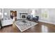 Inviting living room with hardwood floors, a fireplace, and neutral decor at 100 Barnard Pl, Atlanta, GA 30328