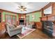 Inviting living room with fireplace, built-ins, hardwood floors, and access to the outdoors at 100 Barnard Pl, Atlanta, GA 30328