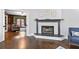 Cozy living room featuring hardwood floors, a fireplace, and an adjacent library at 100 Barnard Pl, Atlanta, GA 30328
