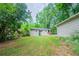 This backyard includes a lush lawn, house exterior, and wooded perimeter at 1774 Austin Dr, Decatur, GA 30032