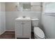 This tiled bathroom includes a sink with cabinet, toilet, mirror, and window at 1774 Austin Dr, Decatur, GA 30032