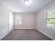 This cozy bedroom features soft carpeting, neutral paint and windows with views of the outdoors at 1774 Austin Dr, Decatur, GA 30032