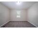 This carpeted bedroom features neutral paint, natural light and a window view at 1774 Austin Dr, Decatur, GA 30032