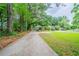 Charming single-story home featuring a long driveway and a lush, green front yard with mature trees at 1774 Austin Dr, Decatur, GA 30032