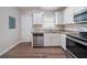 Well-lit kitchen featuring stainless steel appliances and granite countertops, next to door at 1774 Austin Dr, Decatur, GA 30032