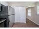 Updated kitchen with modern stainless steel refrigerator and a view to other room through closet door at 1774 Austin Dr, Decatur, GA 30032