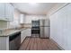 Updated kitchen with stainless steel appliances, granite countertops, and white cabinets at 1774 Austin Dr, Decatur, GA 30032