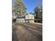 Two-story home with neutral siding, covered carport, and a well-manicured lawn at 1905 Rollingwood Se Dr, Atlanta, GA 30316