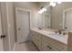 Bathroom featuring double sinks with marble countertops and modern fixtures in a neutral color scheme at 2448 Gatebury Cir, Atlanta, GA 30341
