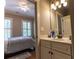 Well-lit bathroom featuring a single sink vanity and a glimpse into the adjacent bedroom with natural light at 2448 Gatebury Cir, Atlanta, GA 30341