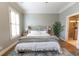 Well-lit primary bedroom with hardwood floors, a ceiling fan, and a walk-in bathroom at 2448 Gatebury Cir, Atlanta, GA 30341