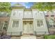 Charming townhome with a light green facade and symmetrical window and door arrangement at 2448 Gatebury Cir, Atlanta, GA 30341