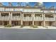 Exterior view of townhomes featuring covered balconies, brick facades, and attached garages at 2448 Gatebury Cir, Atlanta, GA 30341