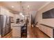 Open kitchen with a large island, stainless steel refrigerator, and sleek cabinetry at 2448 Gatebury Cir, Atlanta, GA 30341