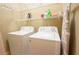 Laundry room with a side-by-side washer and dryer with storage shelves at 2448 Gatebury Cir, Atlanta, GA 30341