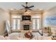 Cozy living room featuring a stone fireplace, ceiling fan, french doors, and comfortable seating at 2448 Gatebury Cir, Atlanta, GA 30341