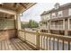 View of an outdoor porch with wood flooring and a railing with townhomes in the background at 2448 Gatebury Cir, Atlanta, GA 30341
