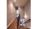 A staircase with hardwood floors and decorative black metal railings lead upstairs at 2448 Gatebury Cir, Atlanta, GA 30341