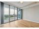 Bedroom with wood floors and floor to ceiling windows leading to the outside balcony at 3338 Peachtree Rd # 1210, Atlanta, GA 30326