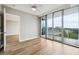 Bedroom with wood floors and floor to ceiling windows leading to the outside balcony at 3338 Peachtree Rd # 1210, Atlanta, GA 30326