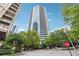 Striking exterior view of a modern high-rise building with a sleek glass facade and lush landscaping at 3338 Peachtree Rd # 1210, Atlanta, GA 30326