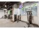 Well-equipped gym featuring modern exercise machines, mirrored walls, and natural light from large windows at 3338 Peachtree Rd # 1210, Atlanta, GA 30326