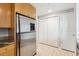 Stainless steel refrigerator located next to a tiled floor and storage closets at 3338 Peachtree Rd # 1210, Atlanta, GA 30326