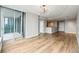 Spacious living room with hardwood floors leading to a sunroom and views of the modern kitchen at 3338 Peachtree Rd # 1210, Atlanta, GA 30326