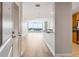 Inviting entrance hall with hardwood floors, offering views of a bright living area and modern kitchen at 3338 Peachtree Rd # 1210, Atlanta, GA 30326