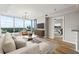 Bright living room with large windows, modern furnishings, and a glimpse into the serene bedroom at 3338 Peachtree Rd # 1210, Atlanta, GA 30326