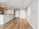 Spacious living area with hardwood floors, offering views of a modern kitchen and a front door at 3338 Peachtree Rd # 1210, Atlanta, GA 30326
