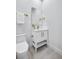 Stylish half-bath with white vanity, gold fixtures, and a sleek mirror for a modern, elegant touch at 337 Pine Ne St # B, Atlanta, GA 30308