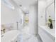 Luxurious bathroom featuring a soaking tub, elegant fixtures, and modern marble flooring for a spa-like experience at 337 Pine Ne St # B, Atlanta, GA 30308