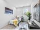 Cozy bedroom featuring white walls, modern decor, and a comfortable bed with a yellow throw blanket at 337 Pine Ne St # B, Atlanta, GA 30308