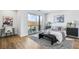 Bright bedroom with sliding glass doors to balcony, stylish decor, and wood flooring at 337 Pine Ne St # B, Atlanta, GA 30308