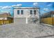 Rear exterior view showcasing a two-car garage and a paved parking pad at 337 Pine Ne St # B, Atlanta, GA 30308