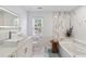 Elegant bathroom showcasing a soaking tub, marble accents, and a modern vanity at 4909 Glenwhite Dr, Duluth, GA 30096