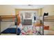 Spacious bunk room with four beds, a colorful rug, and a large window for natural light at 4909 Glenwhite Dr, Duluth, GA 30096