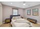 Well-lit bedroom with matching nightstands, artwork, and a comfortable-looking bed at 4909 Glenwhite Dr, Duluth, GA 30096