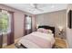 Cozy bedroom with patterned wallpaper, two windows with curtains and a comfortable-looking bed at 4909 Glenwhite Dr, Duluth, GA 30096