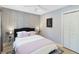 Well-lit bedroom with patterned wallpaper, a comfortable bed, and a spacious closet at 4909 Glenwhite Dr, Duluth, GA 30096