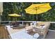 Inviting outdoor deck with comfortable seating, umbrellas, and a peaceful view of the trees at 4909 Glenwhite Dr, Duluth, GA 30096